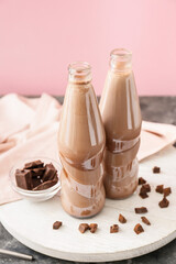 Bottles of tasty chocolate milk on table