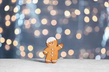 Gingerbread cookie on table against blurred lights