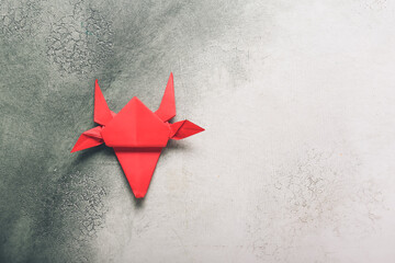 Origami bull as symbol of year 2021 on light background