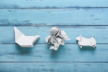 Composition with origami bull on color wooden background