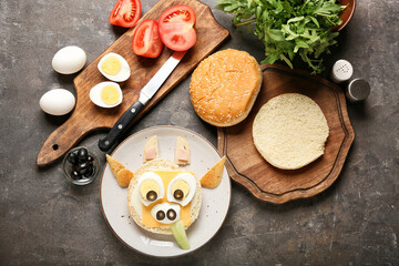 Plate with tasty sandwich in shape of bull on dark background