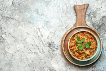 top view roasted eggplant salad in bowl on grey background with free space