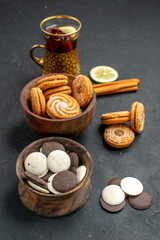 front view cup of tea with different cookies on dark background sweet biscuit tea sugar
