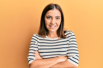 Obraz premium Young beautiful woman wearing casual striped t shirt happy face smiling with crossed arms looking at the camera. positive person.