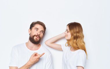 Enamored woman and man t-shirts family friends having fun gesturing with their hands