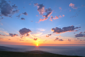 Amazing orange, pink and purple colors of a summer sunset over the city of Dublin view from Fairy Castle, Dublin Mountains, Ireland