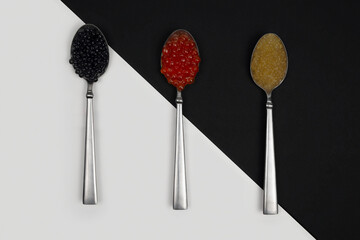 Caviar on a spoon on a black and white background