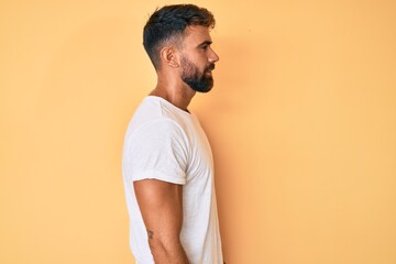 Young hispanic man wearing casual clothes looking to side, relax profile pose with natural face...