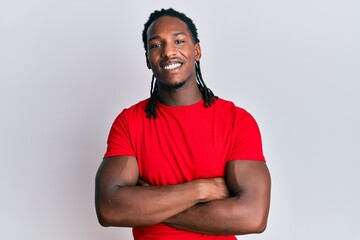 African american man with braids wearing casual clothes happy face smiling with crossed arms looking at the camera. positive person. - obrazy, fototapety, plakaty