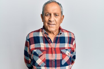 Senior hispanic man wearing casual clothes with a happy and cool smile on face. lucky person.