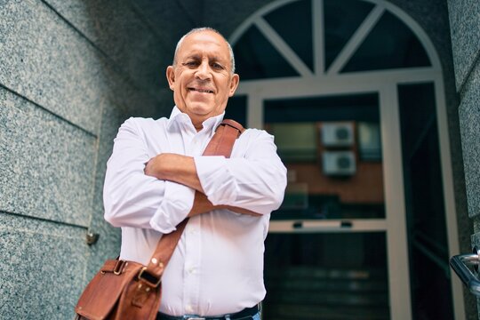 Senior businessman smiling happy walking at the city.