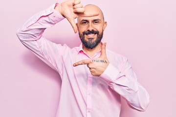 Young handsome man wearing business clothes smiling making frame with hands and fingers with happy face. creativity and photography concept.