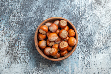 top view fresh hazelnuts inside plate on white background nut walnut peanut