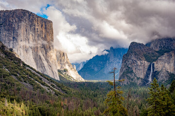 Scenic view of El Capitan, Bridal Falls, and Half Dome Covered in Clouds. Yosemite Valley in...