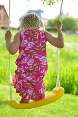 child swinging on swing