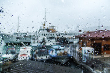 Istanbul passenger ferry view behind window with raindrops. Water droplets on the window. Raining background.