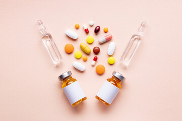 assorted medical supplies isolated on pink background. pills,tablets, capsules and vials composition. pharmacy concept. medicine conceptual. above view