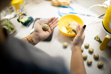 Caucasian woman is doing meatball or italian polpette. Traditional food. Close up and top view