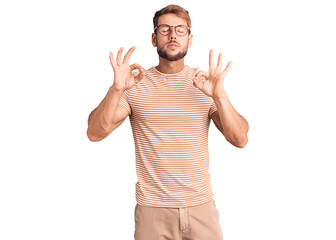 Young caucasian man wearing casual clothes and glasses relaxed and smiling with eyes closed doing meditation gesture with fingers. yoga concept.