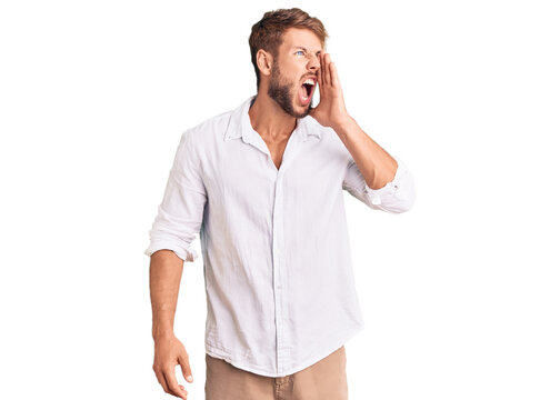 Young caucasian man wearing casual clothes shouting and screaming loud to side with hand on mouth. communication concept.