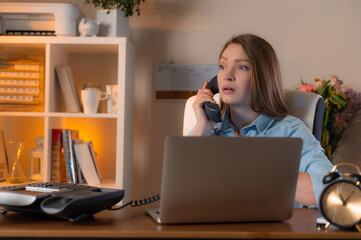 Sad woman siting in office and talking with phone. Bad news.Concept of working moments. Office life.