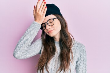 Young beautiful caucasian girl wearing french look with beret surprised with hand on head for...