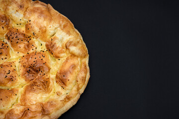 Turkish Ramadan Bread - ramazan pidesi (Pita) isolated on black. Traditional popular food for fasting in holy Ramadan month in Turkey