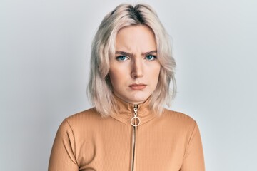Young blonde girl wearing casual clothes skeptic and nervous, frowning upset because of problem....
