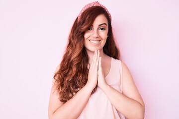 Young beautiful woman wearing casual clothes praying with hands together asking for forgiveness smiling confident.