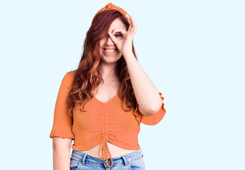 Young beautiful woman wearing casual clothes smiling happy doing ok sign with hand on eye looking through fingers