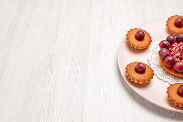 front view delicious cakes with grapes on white background biscuit pie desserts