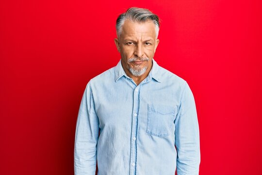 Middle age grey-haired man wearing casual clothes skeptic and nervous, frowning upset because of problem. negative person.