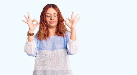 Young latin woman wearing casual clothes relaxed and smiling with eyes closed doing meditation gesture with fingers. yoga concept.