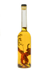 Glass bottle of premium virgin olive oil  with spices and herbs isolated on a white background. Chili olive oil. Olive oil with paprika or red pepper.