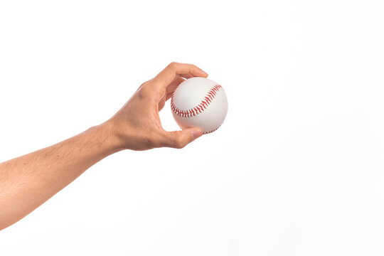Hand of caucasian young man holding baseball ball over isolated white background