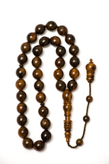Brown prayer beads on white background