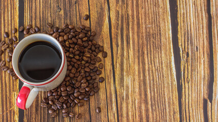 Morning coffee menu with roasted coffee beans and wooden background can be used as a background.