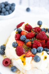 Pavlova with strawberries, raspberries, blueberries and passionfruit for Christmas