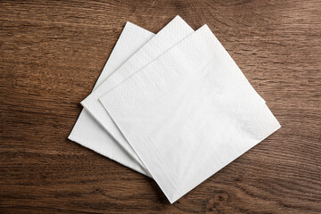 White clean paper tissues on wooden table, top view