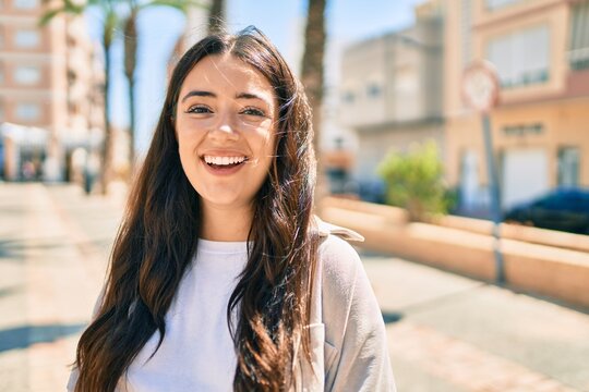 Young hispanic woman smiling happy walking at the city.