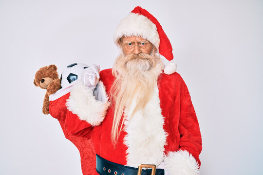Old senior man with grey hair and long beard wearing santa claus costume holding mustache depressed and worry for distress, crying angry and afraid. sad expression.