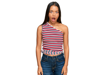 Beautiful hispanic woman wearing casual clothes afraid and shocked with surprise expression, fear and excited face.