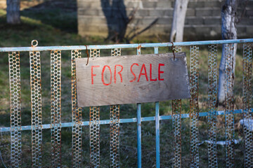 For sale sign on fence