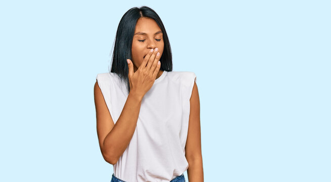 Young african american woman wearing casual clothes bored yawning tired covering mouth with hand. restless and sleepiness.