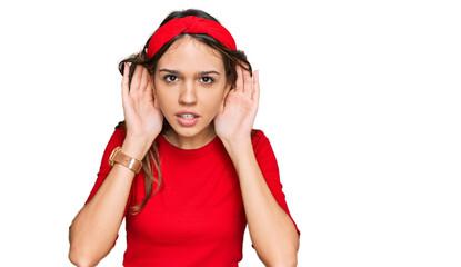 Young brunette woman wearing casual clothes trying to hear both hands on ear gesture, curious for gossip. hearing problem, deaf