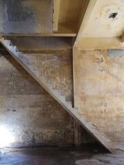The interior and old staircase in dirty warehouse. Dark and Old abandoned building. 