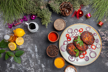 Fototapeta na wymiar top view yummy meat cutlets with seasonings on the light-grey background meal photo dish