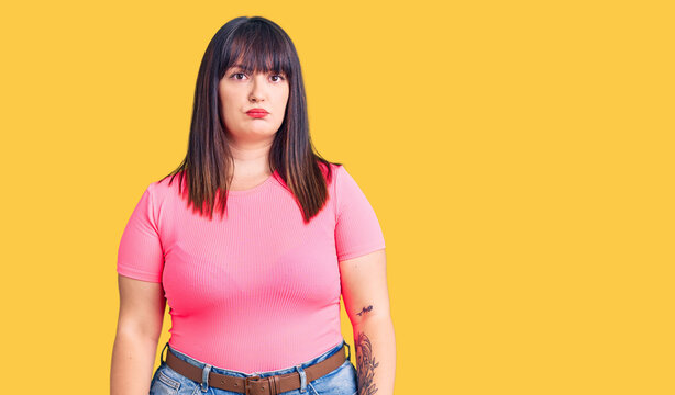 Young plus size woman wearing casual clothes depressed and worry for distress, crying angry and afraid. sad expression.