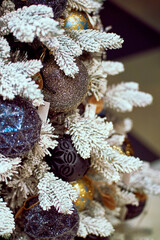 bright different Christmas toys balls on a tree for close-up