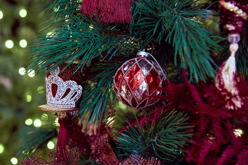bright different Christmas toys balls on a tree for close-up